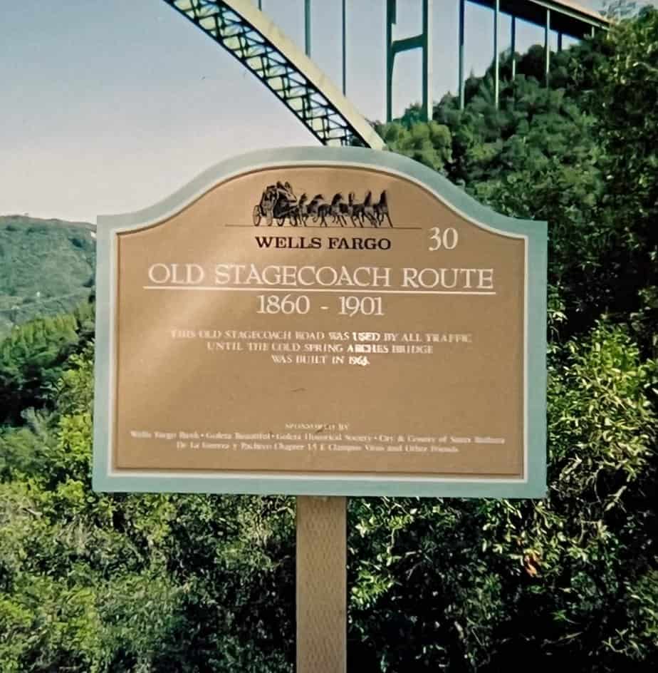 An informative sign marks the Wells Fargo 30 Old Stagecoach Route. Cold Spring Canyon Arch Bridge stands in the background.