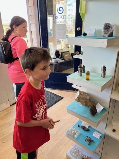 Our kids admire the stones and watch Astro the robot at Troxel's Gem Store. Troxel's is one of the best things to do on the Oregon Coast with kids.