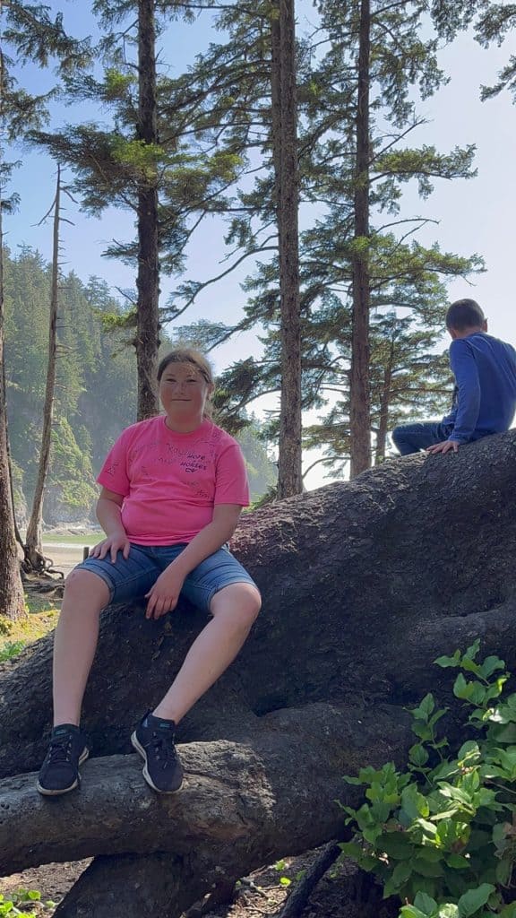 Our children play on the enormous roots of an old-growth Sitka Spruce Tree at Short Sand Beach. Short Sand Beach is one of the best things to do on Oregon Coast with kids.