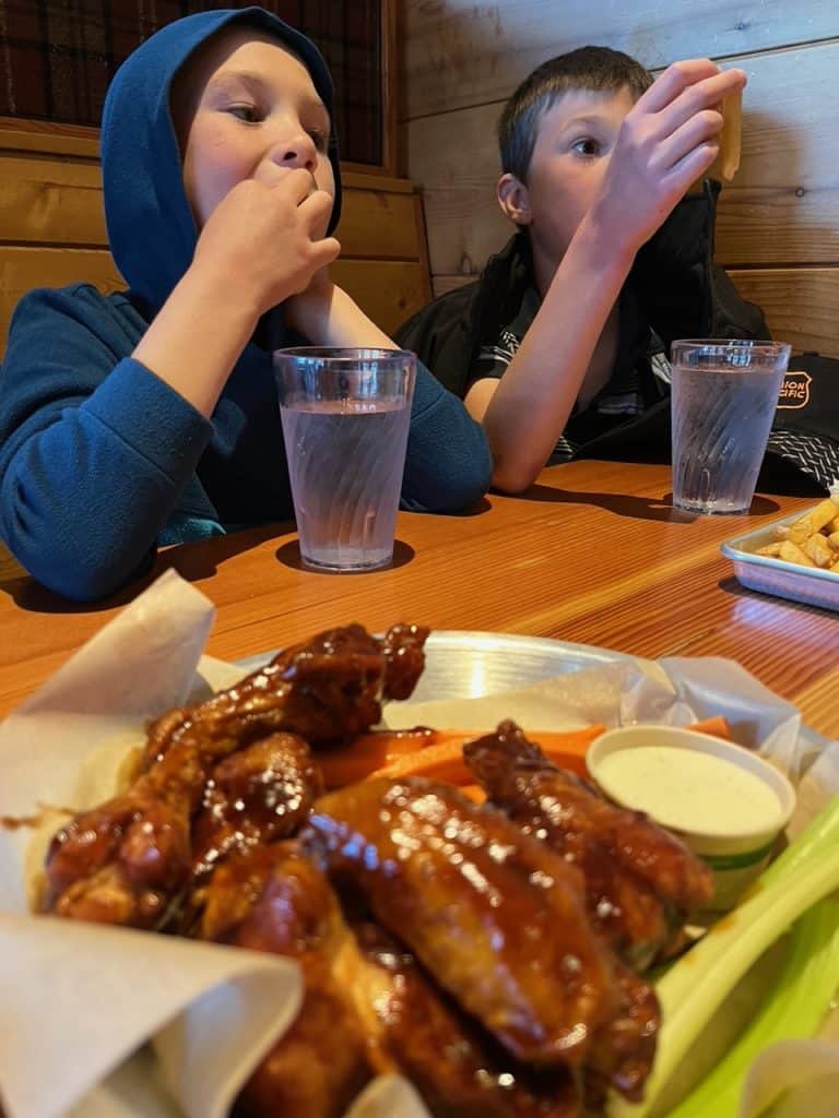 Our boys try out root beer flavored bbq wings at Public Coast Brewing Company. 