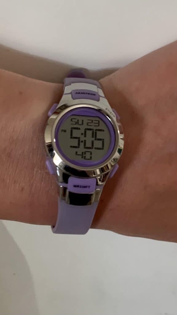wrist with purple watch. ADHD timers.