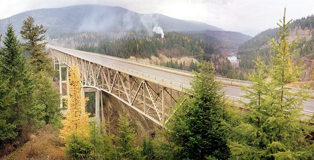 A panorama show the Moyie River Bridge and its surrounding forestland.