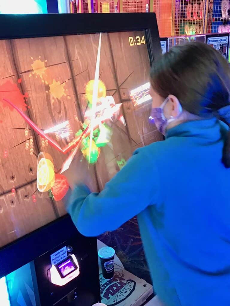 Girl playing Fruit Ninja at the Funland Arcade in Seaside Oregon