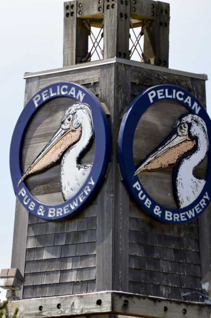Pelican Pub & Brewery logo and sign on a tower in Pacific City.