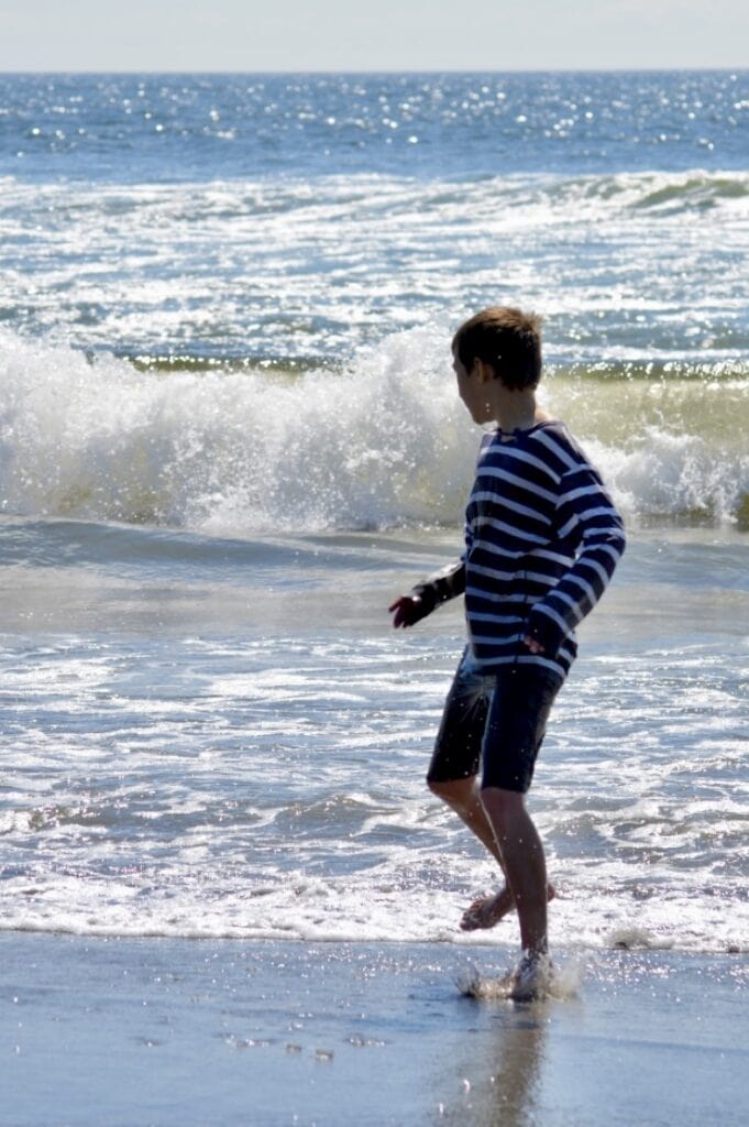 Boy splashing in the waves. 