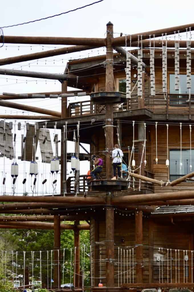 People climbing the aerial challenge course at High Life Adventure Park.