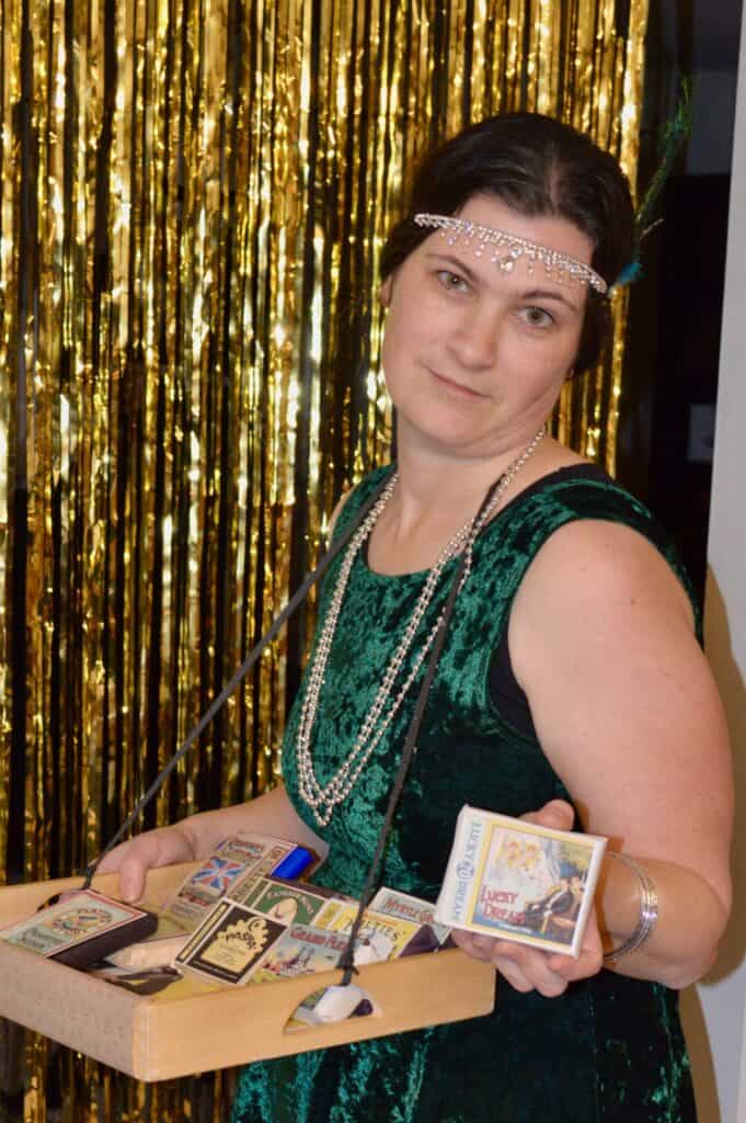 Jenn in 1920s cigarette girl costume for a murder mystery dinner. Halloween activities for teens.