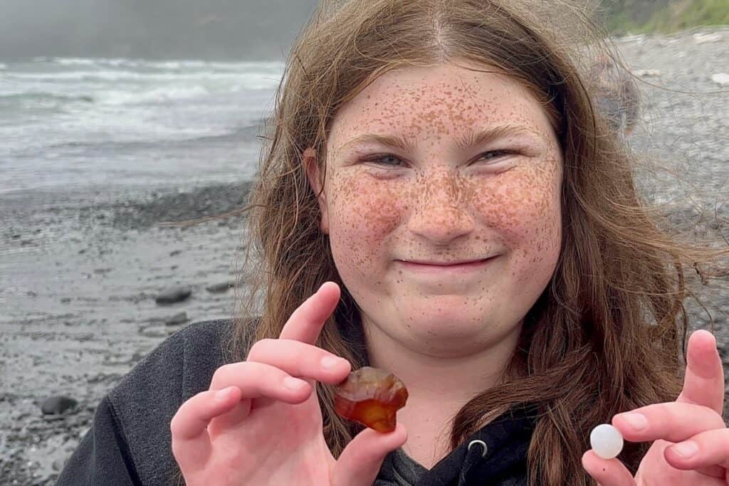 Our daughter with two of the beautiful rocks she found at Short Beach.