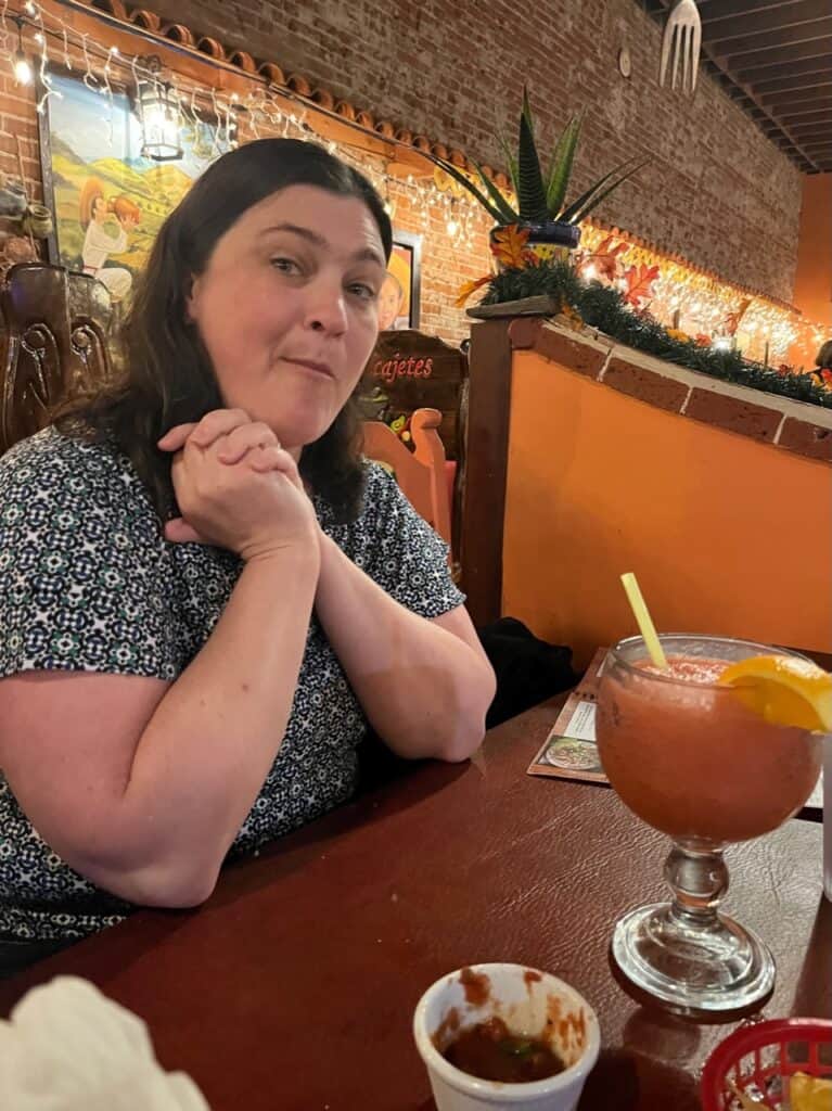 Jenn with a large strawberry margarita at  Las Molcajetes.