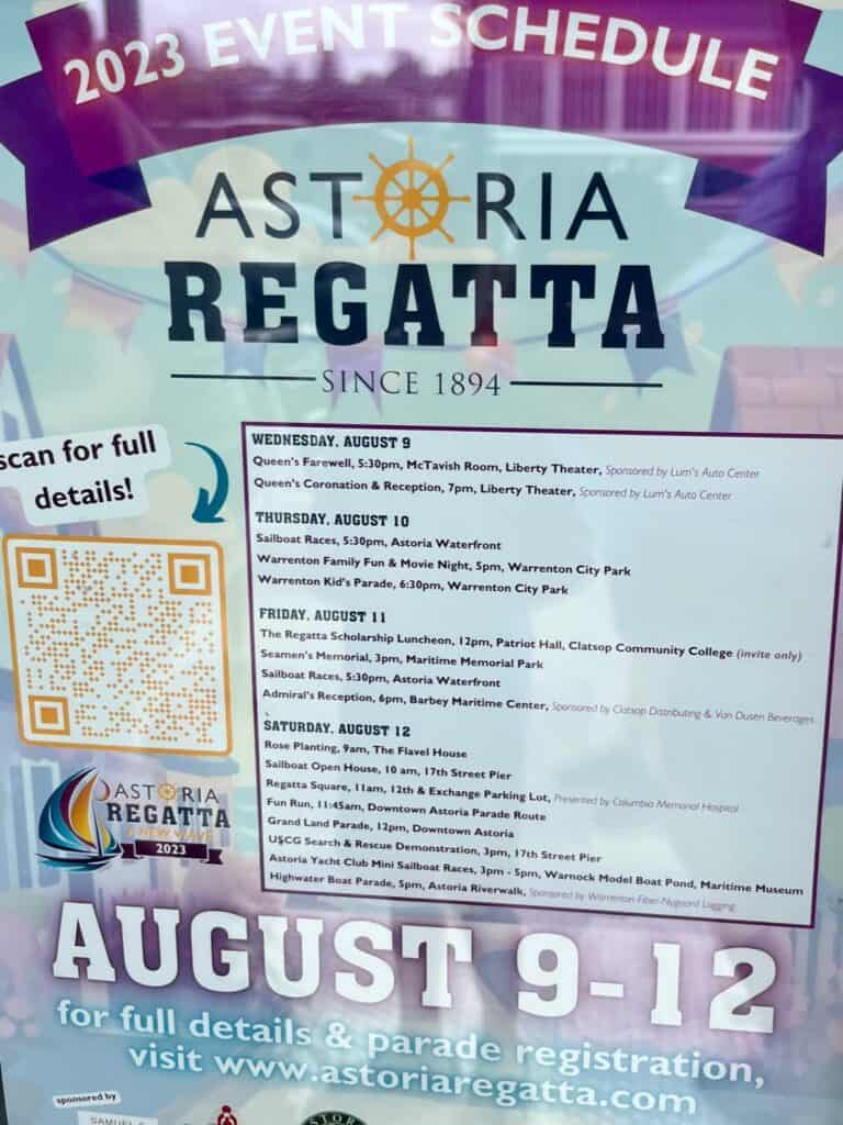 Poster in a window for the 2023 Astoria Regatta.