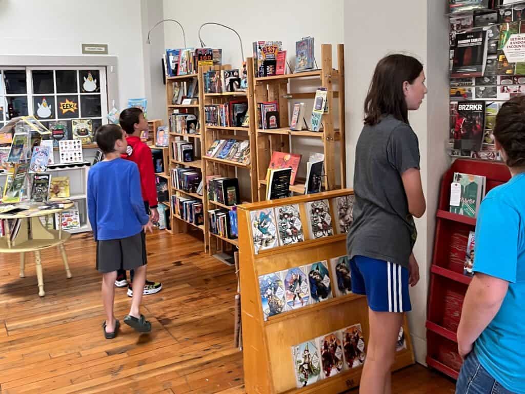 Teens and kids exploring Lucy's bookstore in Astoria Oregon.