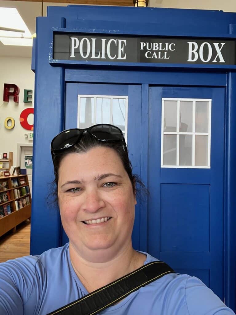 Me in front of the blue Police Public Call Box (Doctor Who's Tardis) inside of Lucy's Books in Astoria.