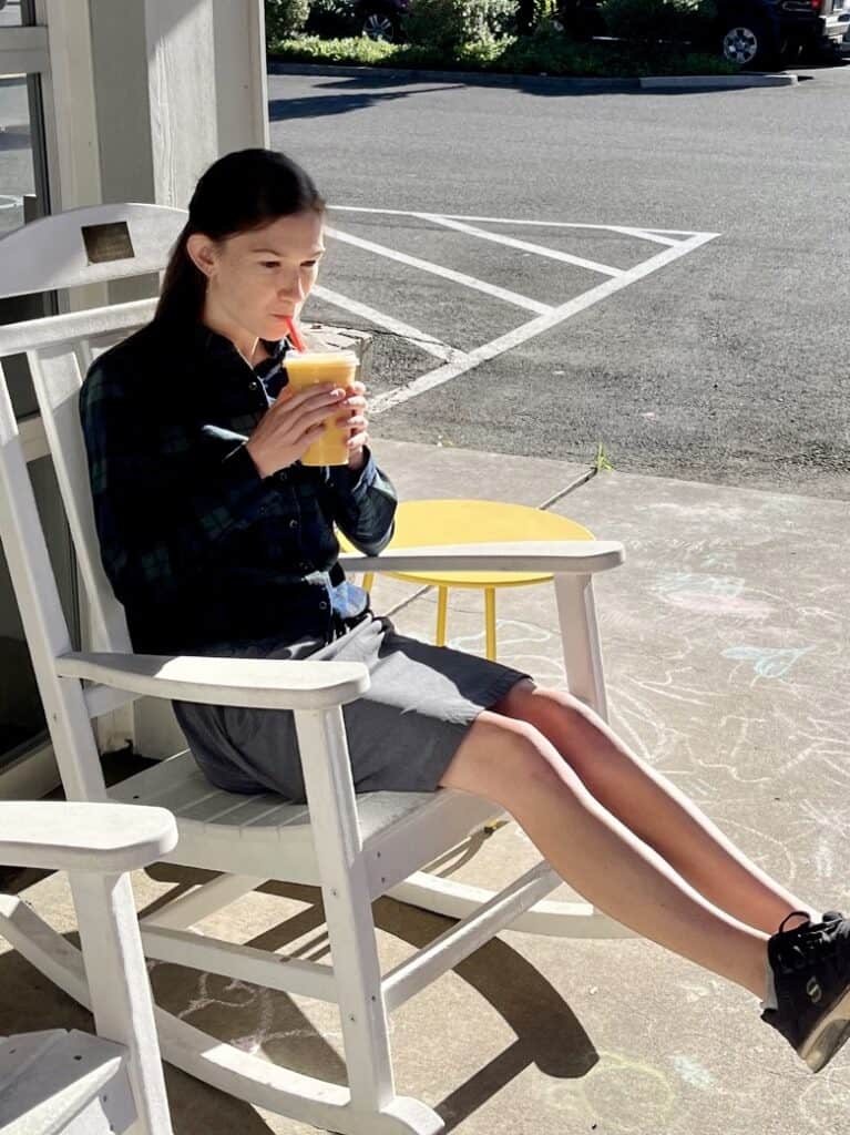 Our daughter sipping a drink in a rocking chair at a local coffee shop. What ADHD looks like in teen girls.