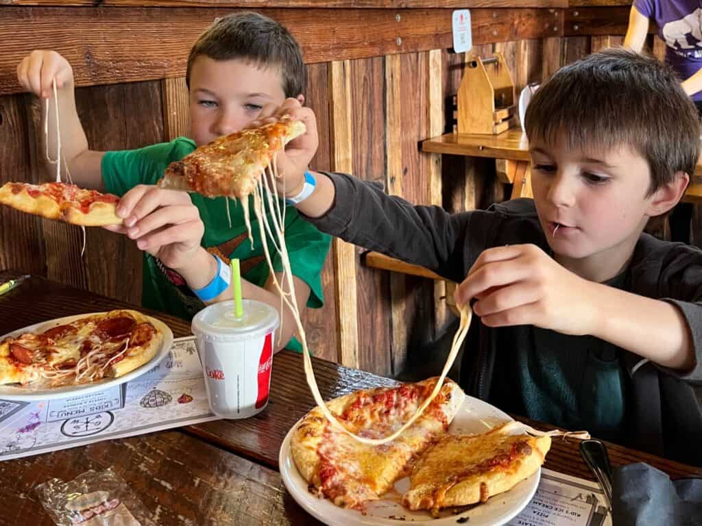 Our boys stretching the cheese on their pizza. Kid-friendly things to do in McMinnville Oregon.