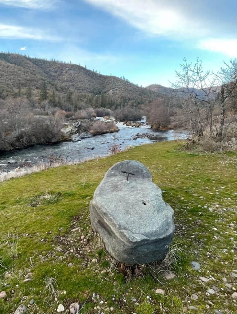 The story-telling stone sits beside the Rogue River on the California National Historic Trail. The California National Historic Trail is one of the best national parks to visit in November and December.