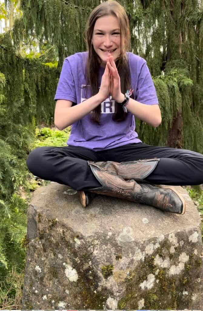 Our oldest daughter on a rock in a yoga pose. ADHD in teen girls.