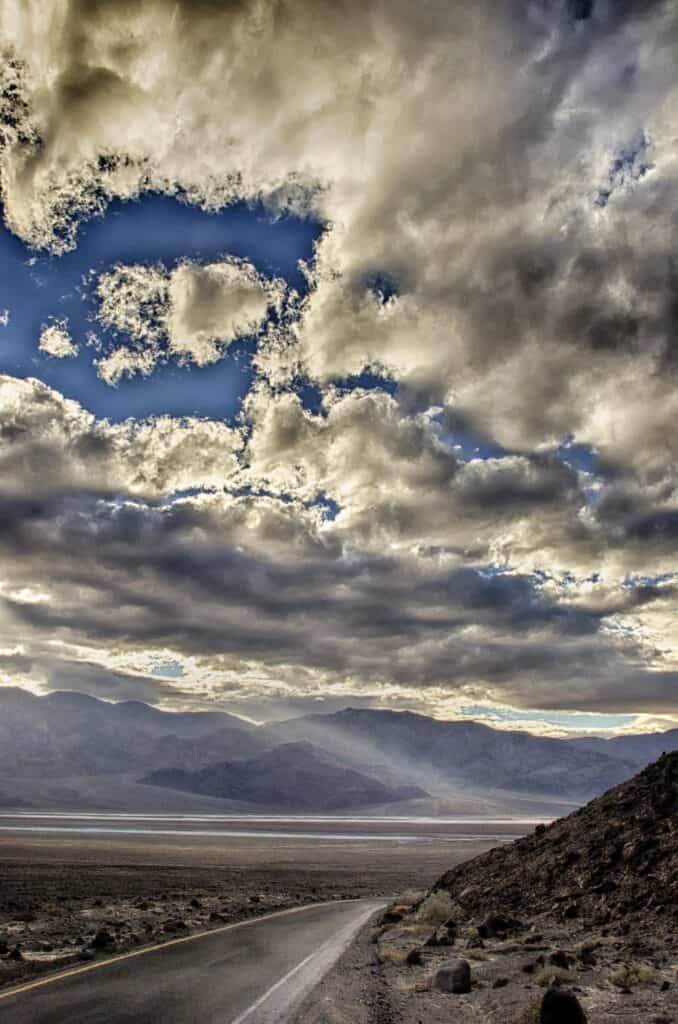 Cloud cover and streams of light illuminate Death Valley National Park.