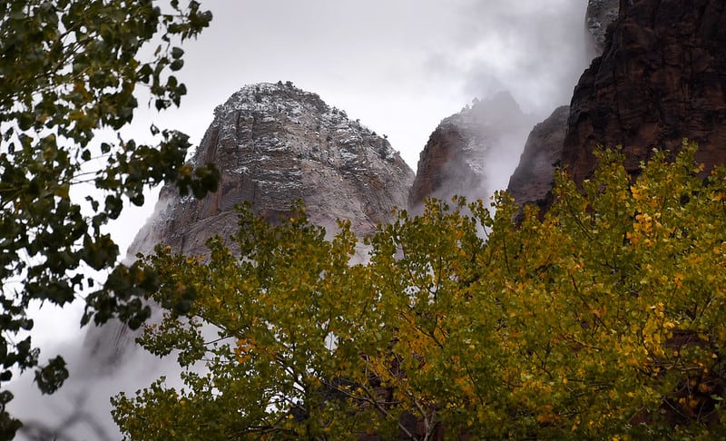 Snow glazes a rocky peak at Zion National Park. Zion National Park is one of the best national parks to visit in November and December.