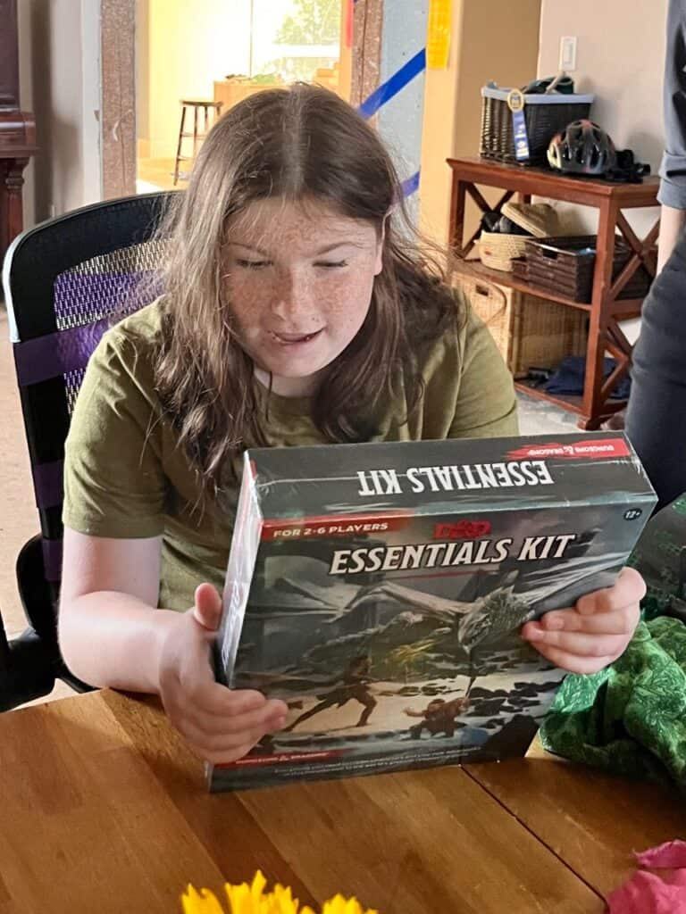 Our youngest daughter holds her new Essentials Kit for Dungeons and Dragons. Gifts for Dungeon Masters.