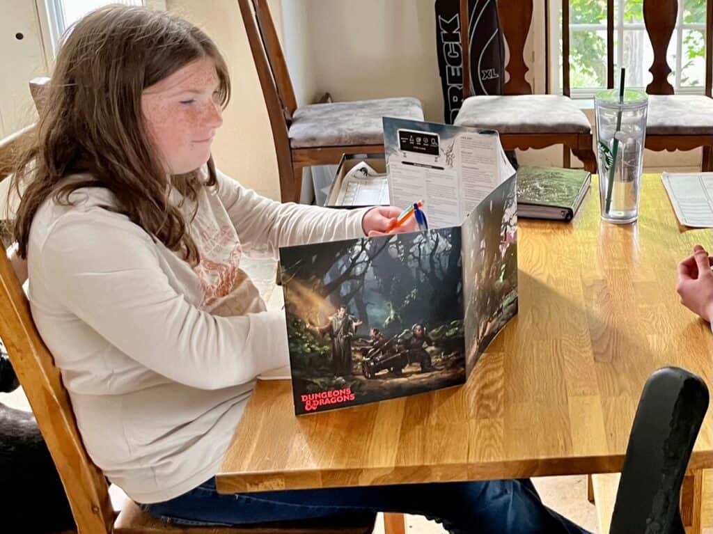 Our daughter setting up a D&D campaign using her DM screen. 