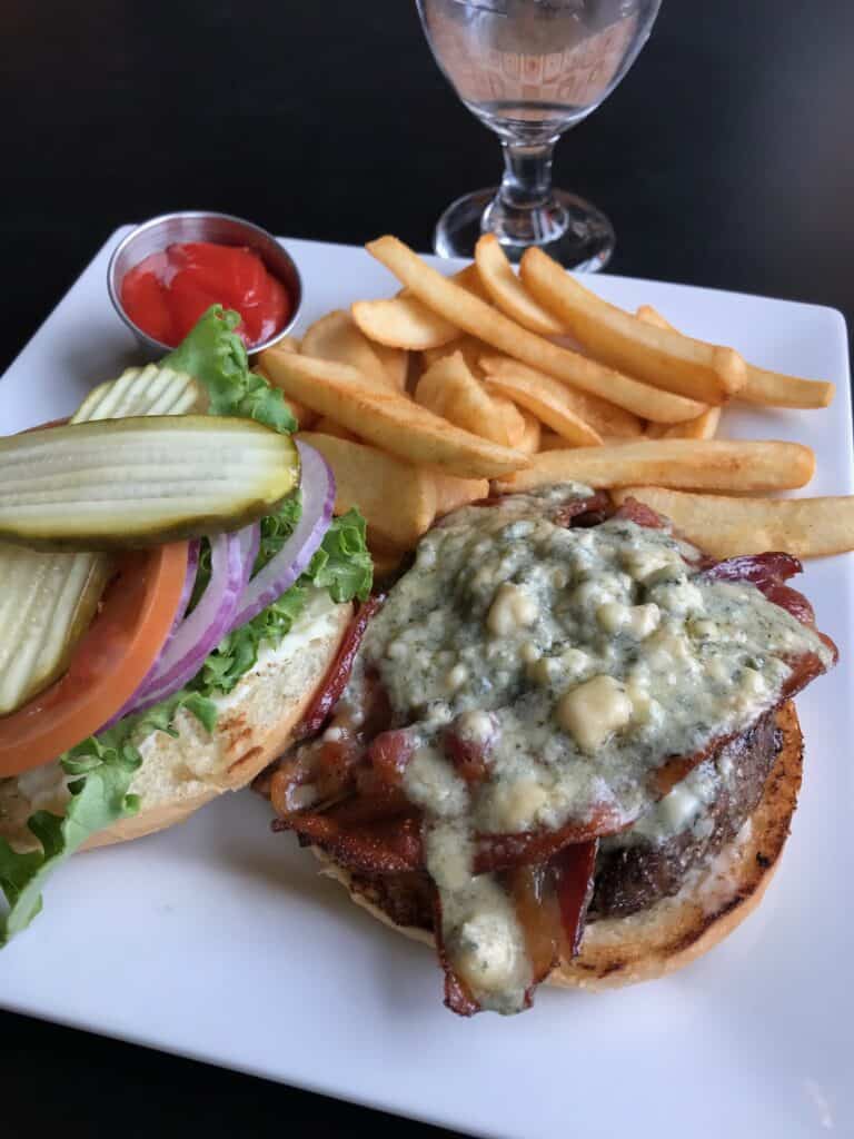 Bacon and bleu cheese topped burger with French fries at the Garden View Restaurant.