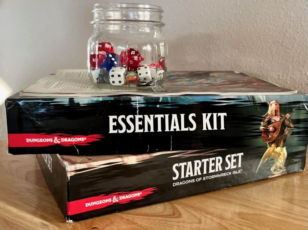 Stack of D&D sets and dice in a jar. 