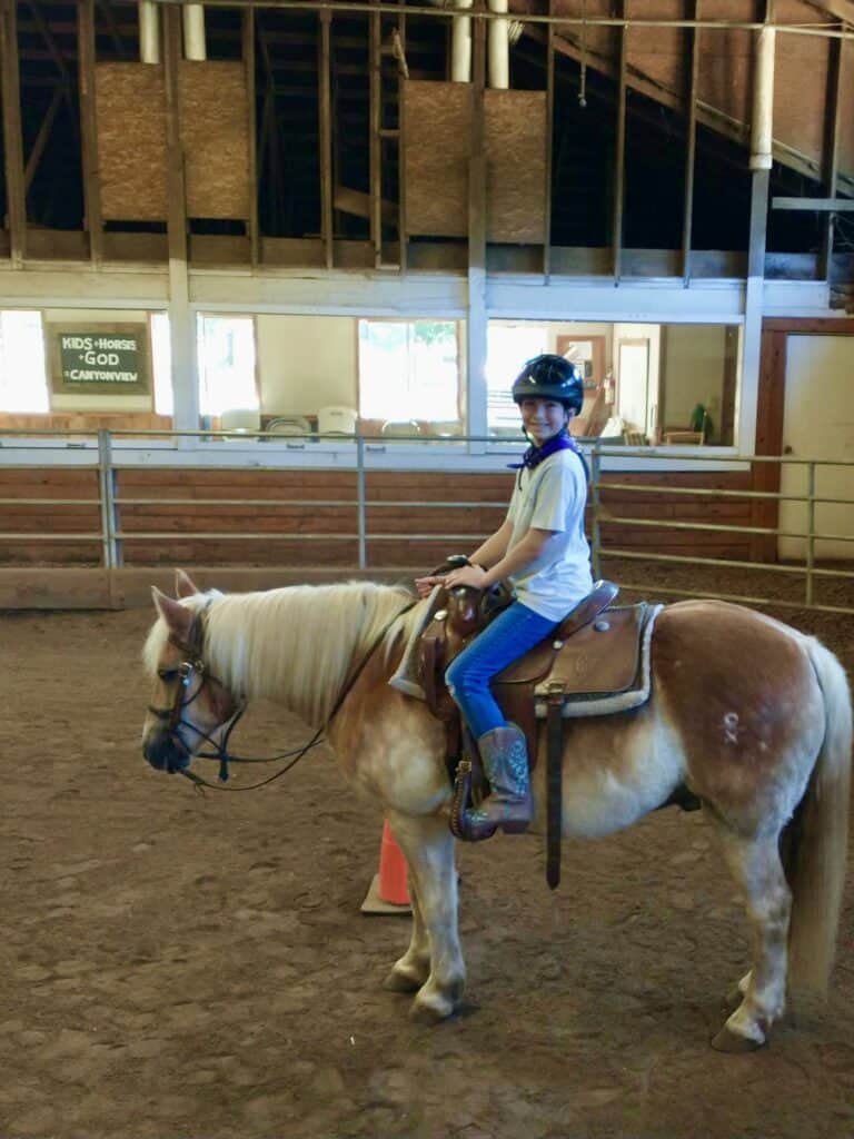 Our second daughter on horseback in the equestrian ring.