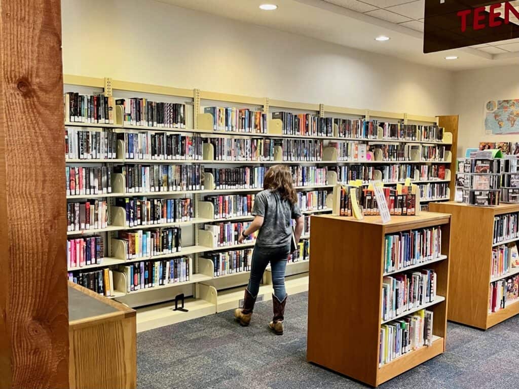 Our daughter checking out the teen book section in the Silver Falls Library.
