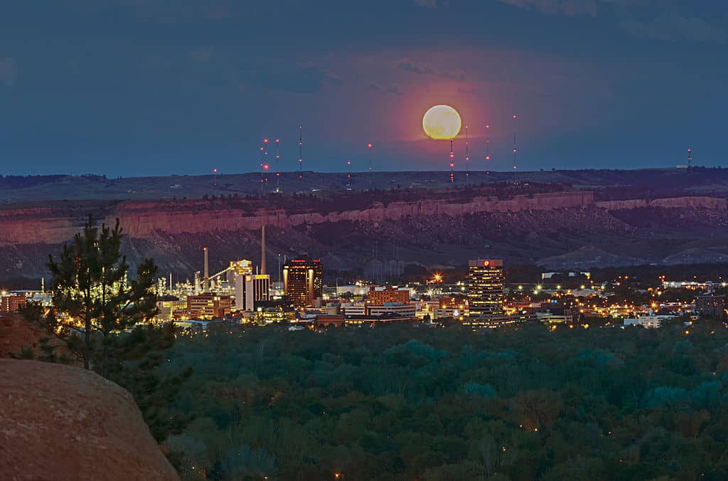 A summer moon rises over the Billings skyline. Billings is an excellent place to discover the best restaurants in Montana.