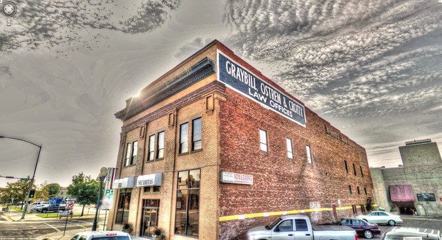 A historic brick building dominates an intersection in Great Falls, Montana. Great Falls is a natural place to find the best restaurants in Montana.