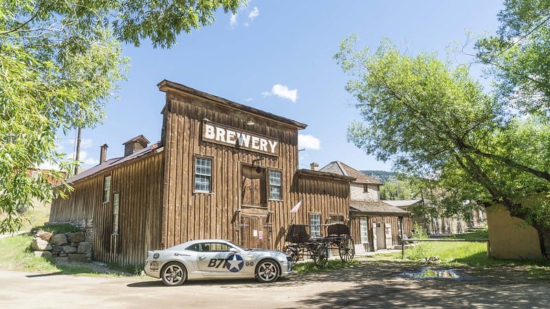 A muscle car sits in front of a brewery in Montana's Yellowstone Country. At least three of Montana's best restaurants are near to Yellowstone National Park.