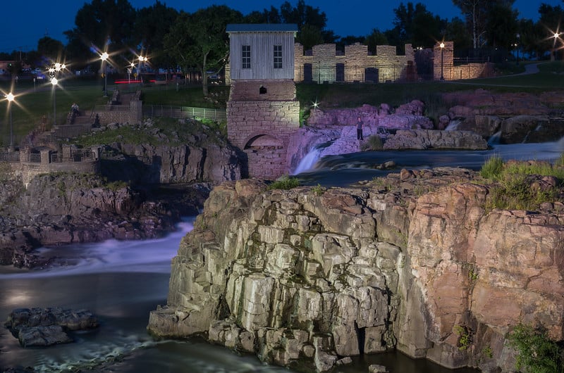 Lamps light up the historic ruins at Falls Park in Sioux Falls. Falls Park is one of the best things to do near Mitchell SD.