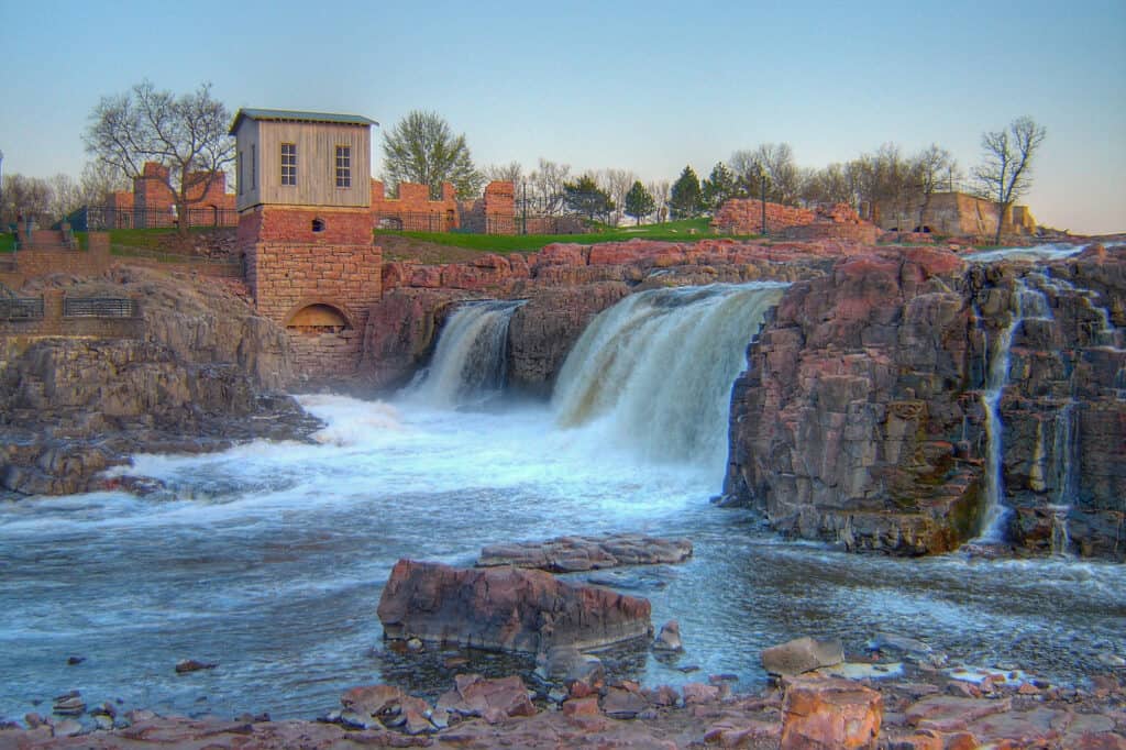 Water cascades down the falls at Falls Park in Sioux Falls. Falls Park is one of best things to do near Mitchell SD.