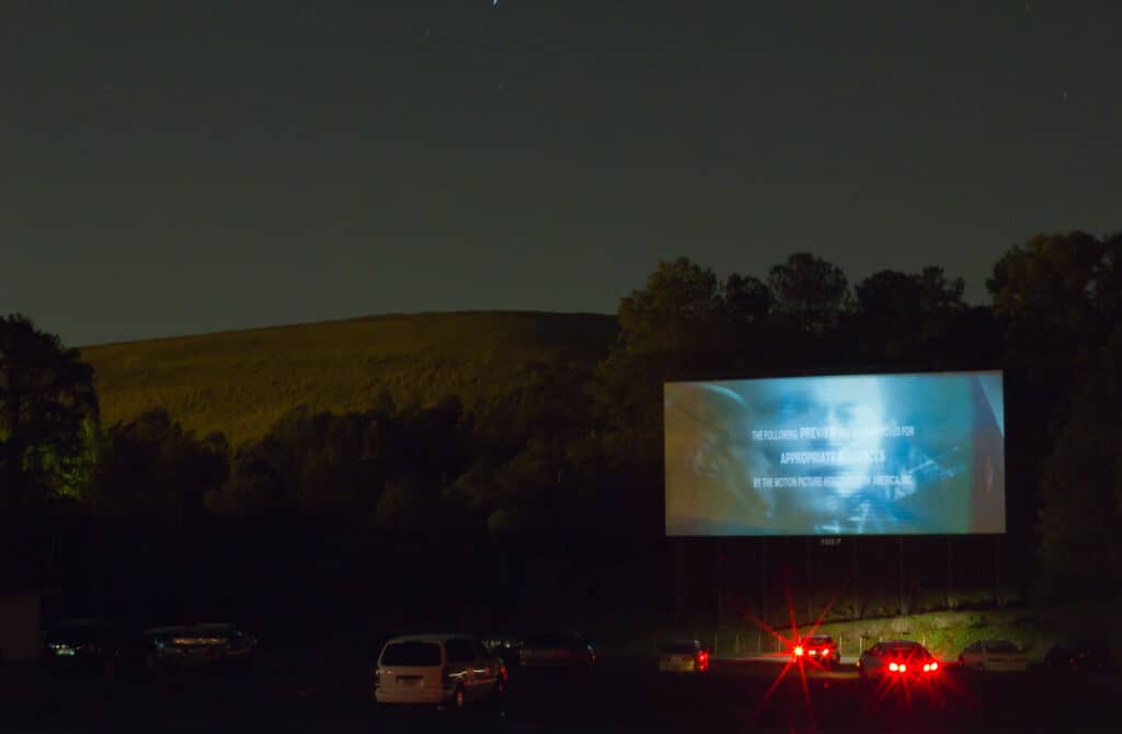 A movie shines on the screen at a Starlight Drive-in Movie theater. The Starlight Drive-in theater is one of the best things to do in Mitchell SD.