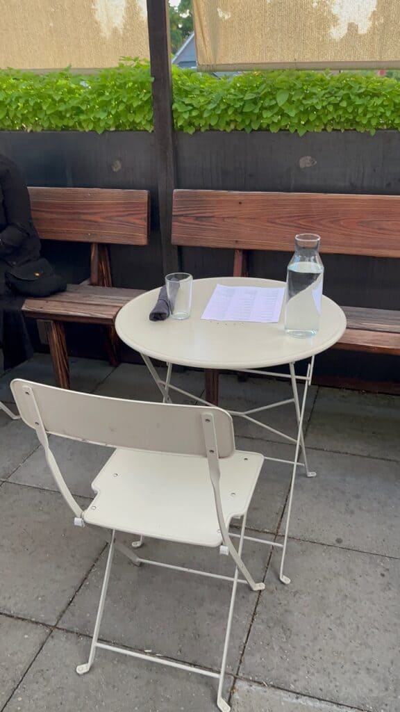 A simple yet elegant bistro table and chair awaits at the rooftop patio of the Little Star Diner. 