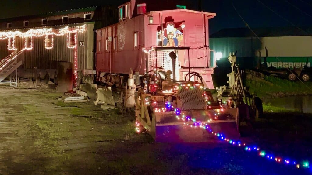 Historic caboose and railcar decorated for Christmas at Powerland Holiday Sparkles.