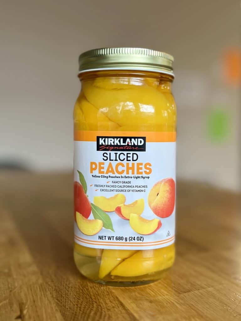 Glass jar of Kirkland canned peaches.