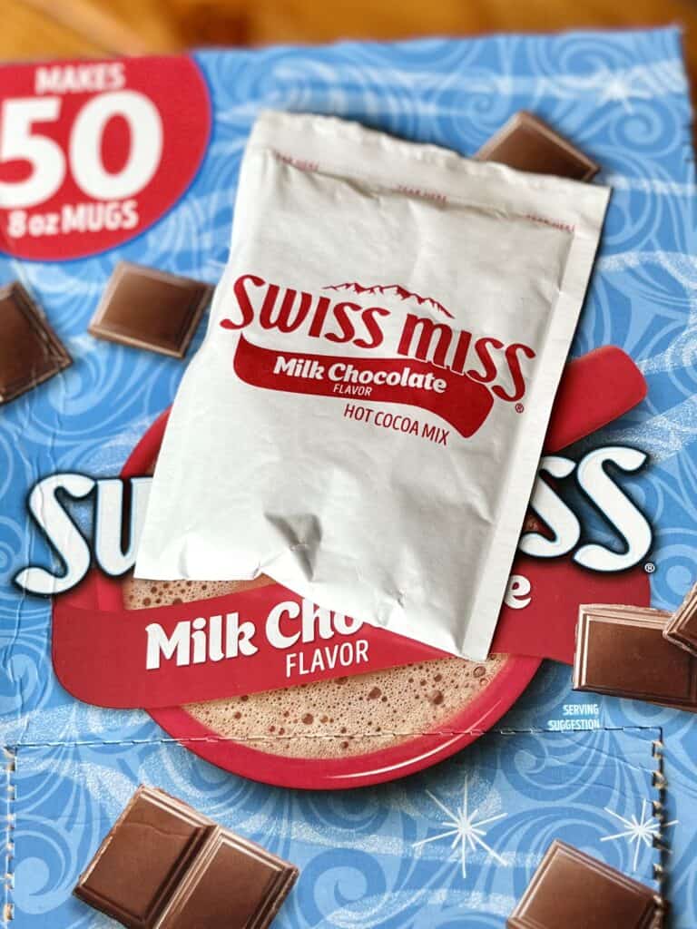 Swiss Miss hot cocoa packet with box behind. 