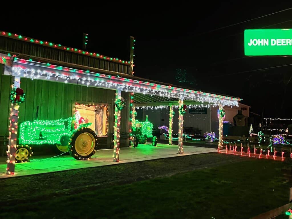 John Deer historic building with tractors, completely decked out with Christmas lights.