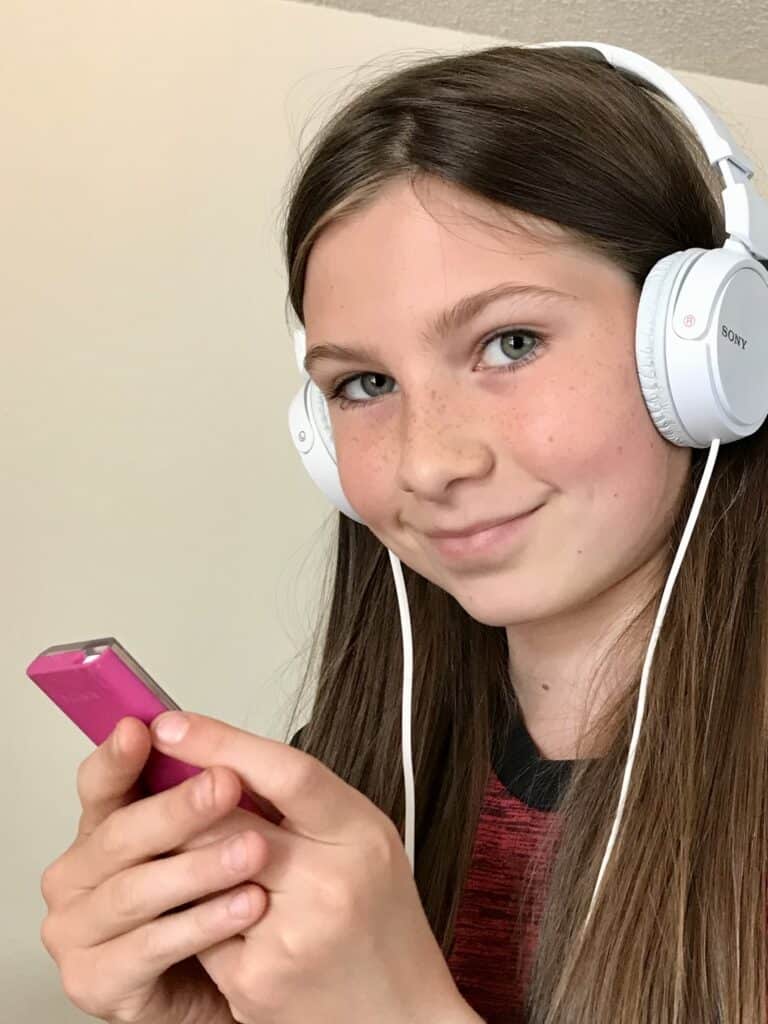 Our daughter with an iPod and headphones.