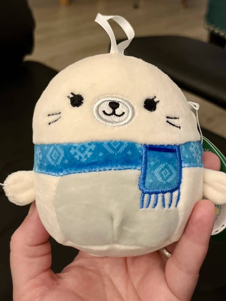 Seal squiishmallow with blue scarf.