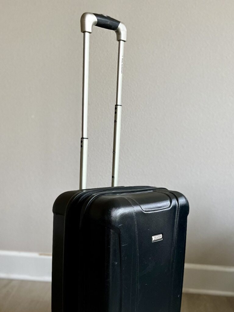 Rolling suitcase showing extended handle.