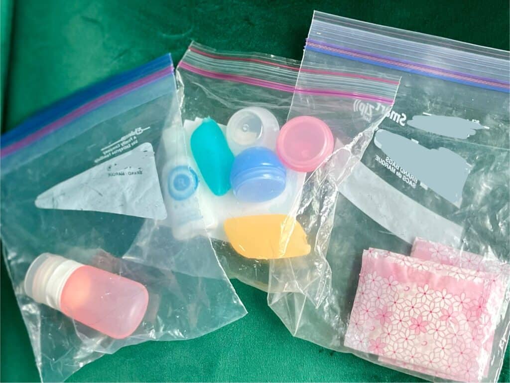 Travel sized toiletries containers in plastic Ziplock bags.