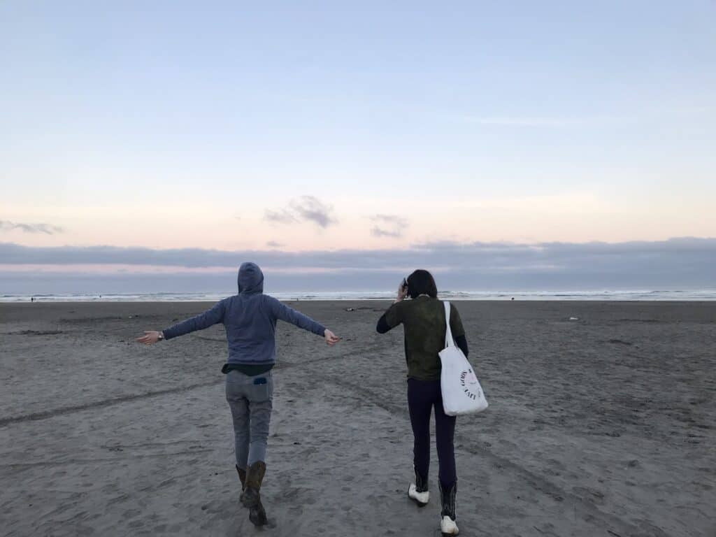 Our teen daughters walking on the Seaside Beach in the early morning.