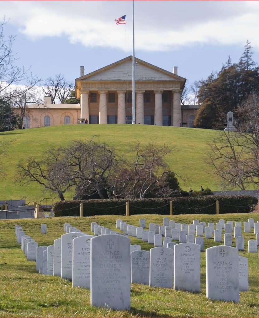 The stately front of Arlington House looks over fields of gravestones at Arlington National Cemetery.