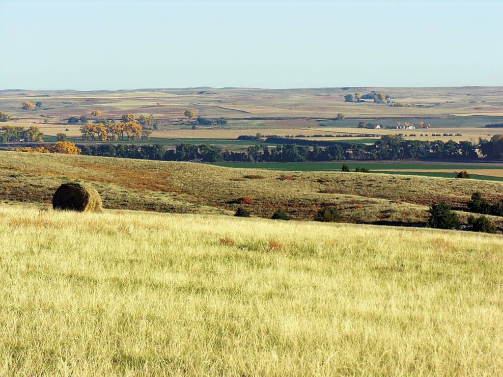 A lonely hay bale looks over rolling Nebraska farmland along the California National Historic Trail.
