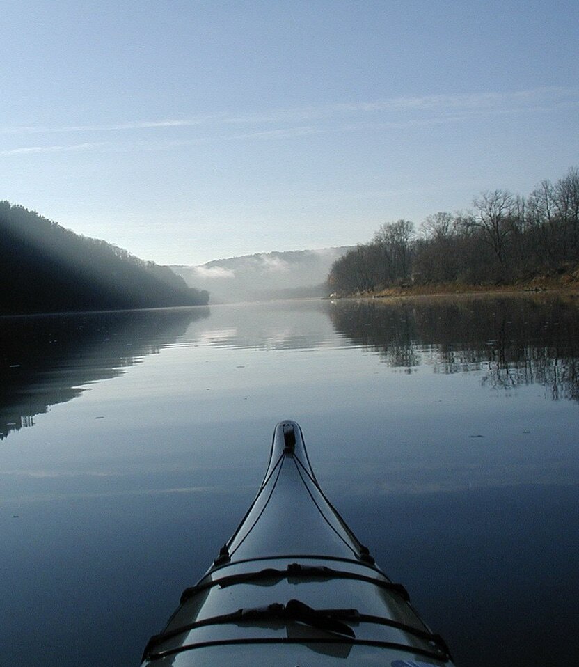 A kayak glides along calm waters along the Captain John Smith Chesapeake National Historic Trail.