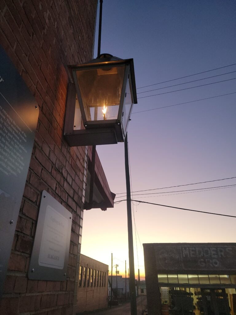 A flame burns in a lantern at the historic gray hound stop of Freedom Riders National Monument.
