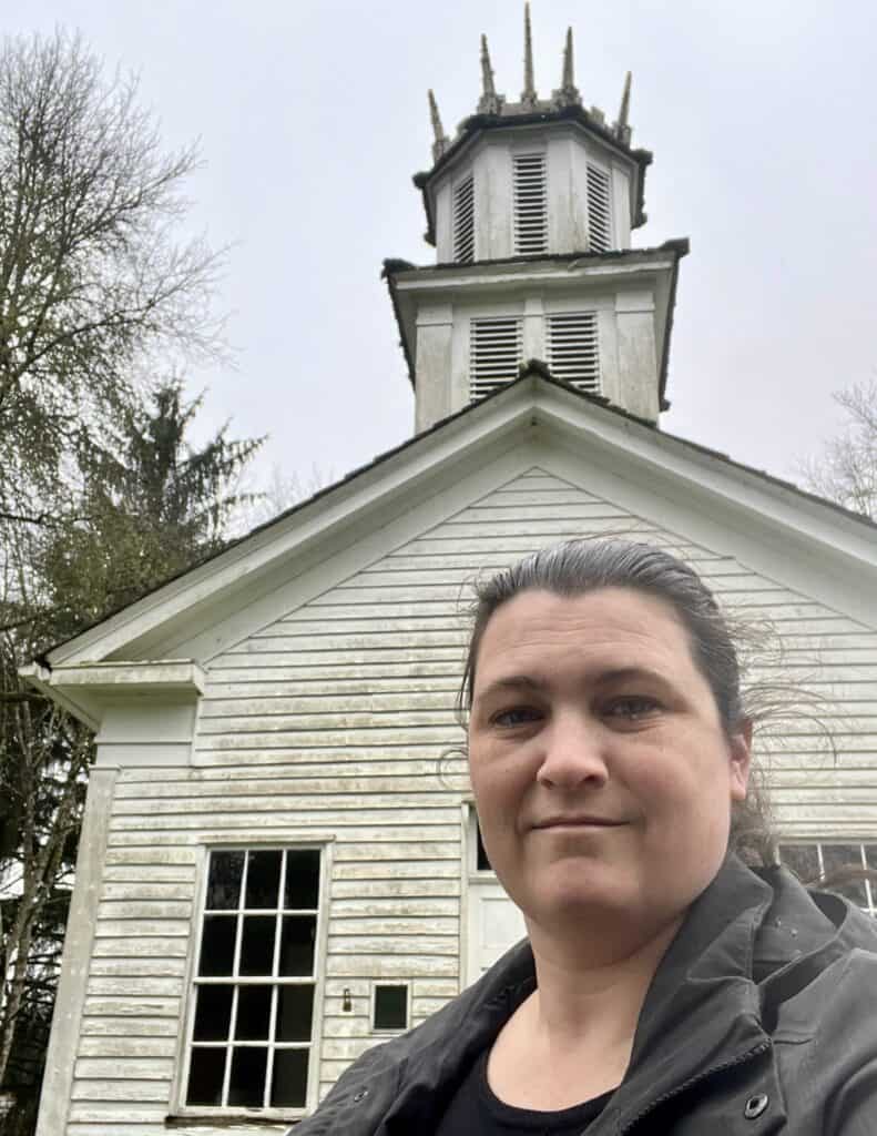 Jennifer takes a selfie with a historic church building along Oregon National Historic Trail, Washington.