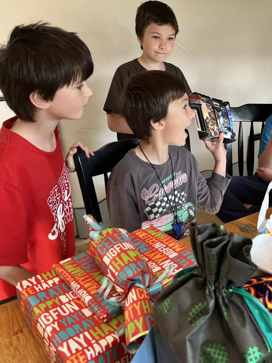 Our son holds up a new Pokemon deck that he received for his birthday.